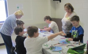 Yvette Chieves, 4-H volunteer leader, leads a session where youth created a Submarine Porthole Aquarium.